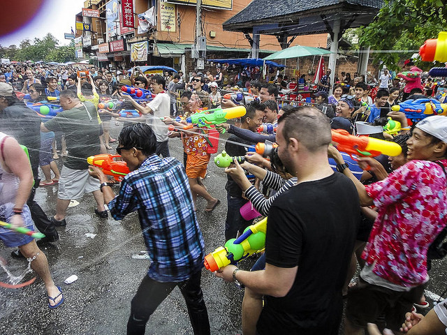 Crowd of people having Super Soaker water gun fight